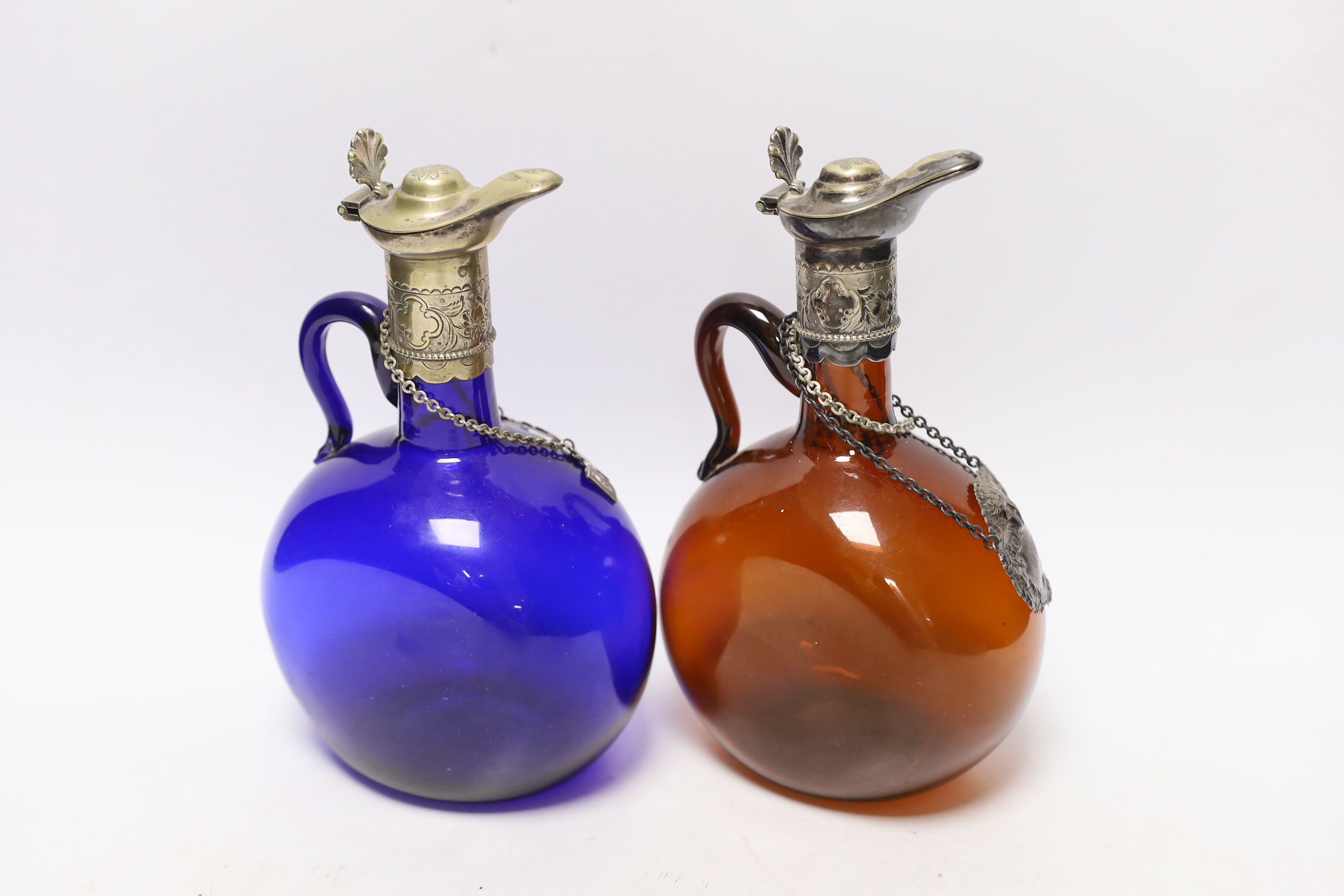 Two Victorian electroplate mounted glass spirit flasks, a silver whisky label and two plated spirit labels